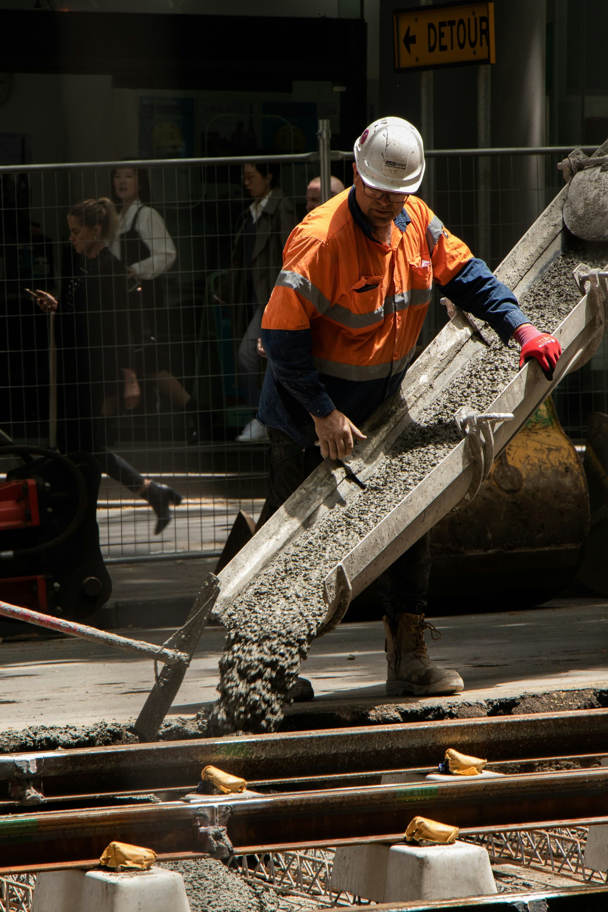 contractor pouring concrete from a ready-mix truck into a new construction project