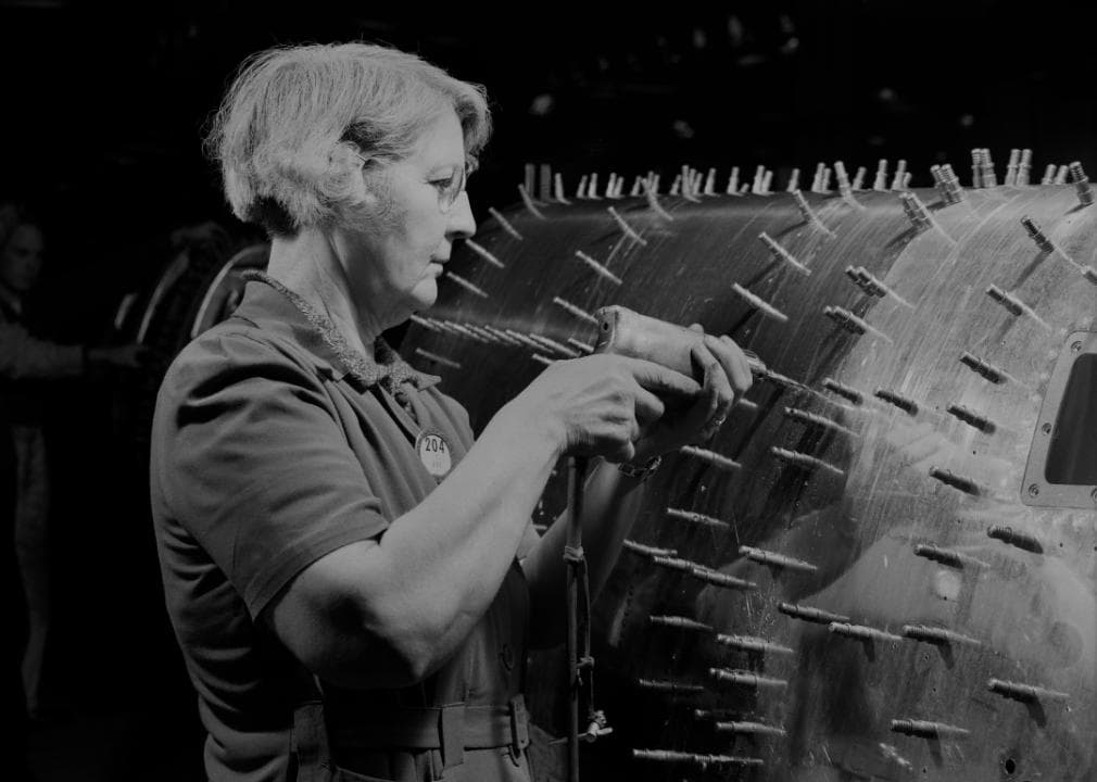 A woman drilling holes in a B-17F Flying Fortress at Boeing in Seattle