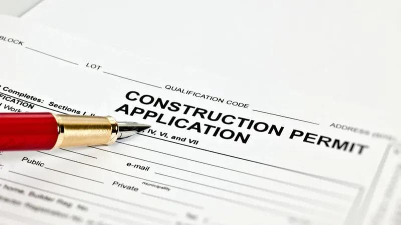 construction application permit with a red ball point pen
