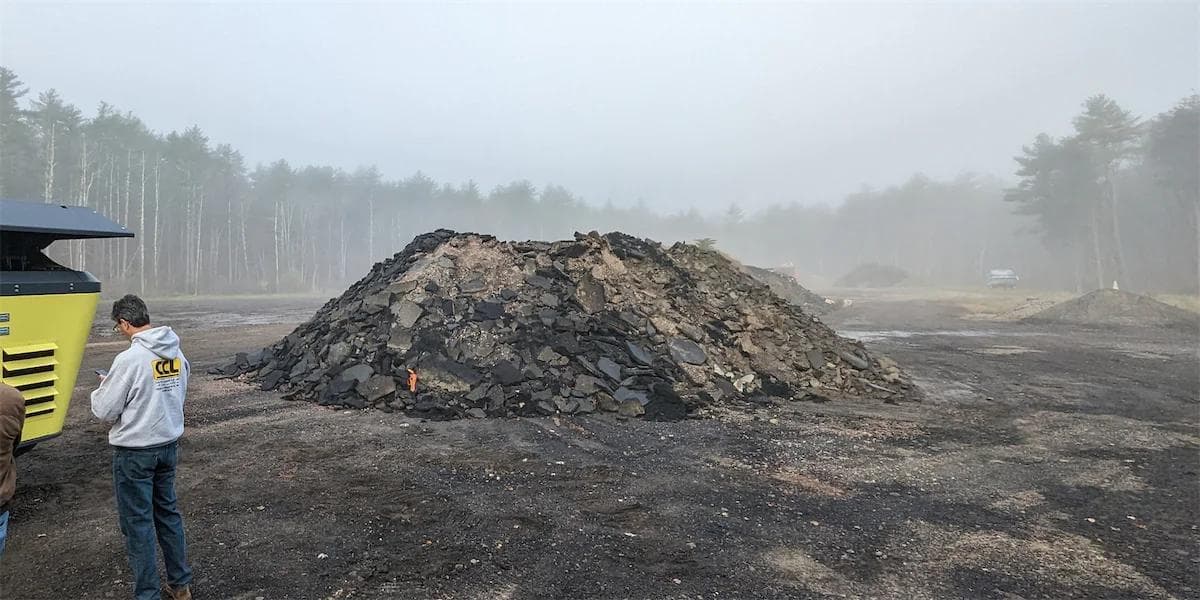 large pile of asphalt ready to be crushed. blacktop driveway that has been broken up