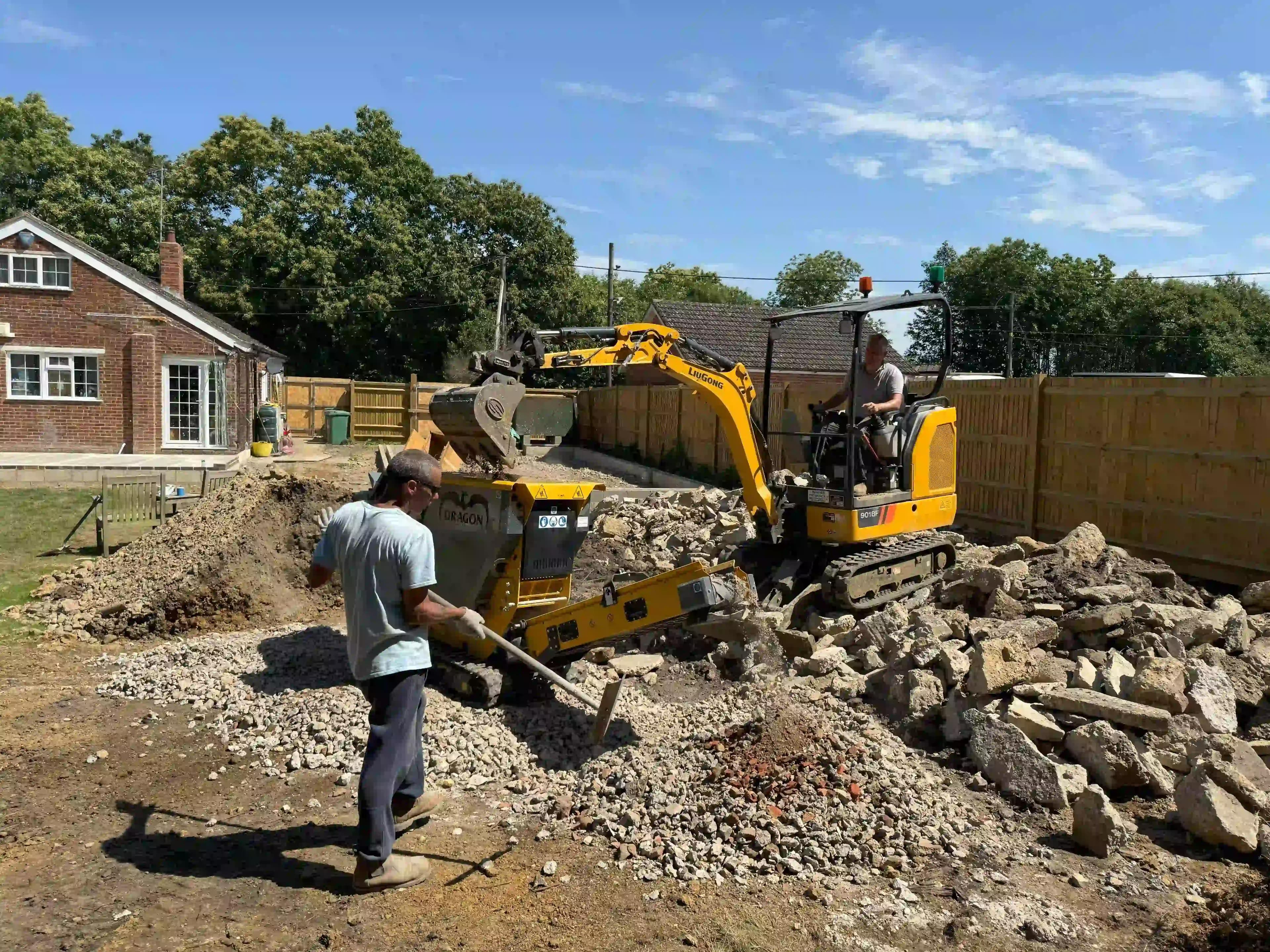 Dragon crusher crushing concrete in a back yard