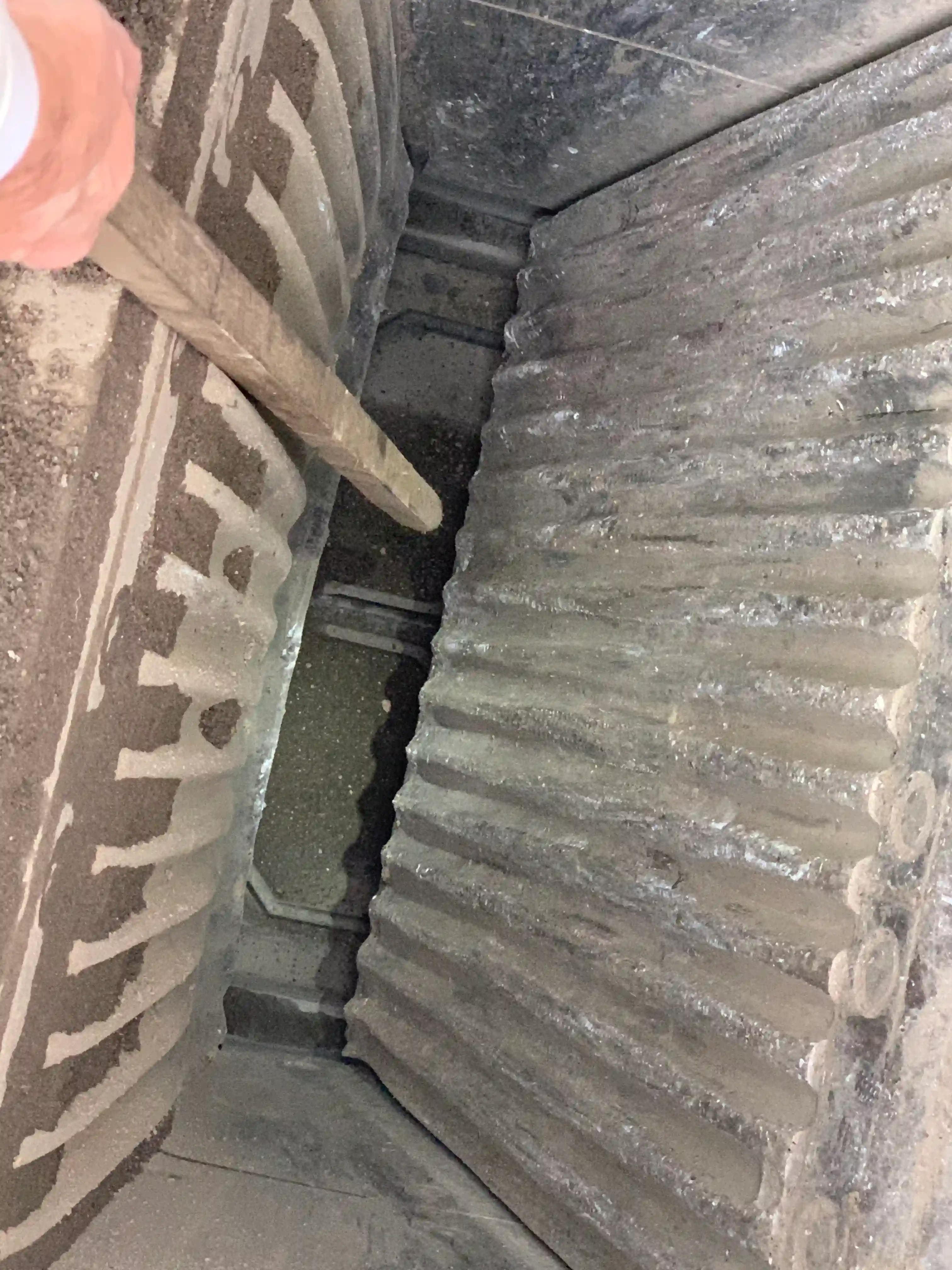 jaw box with wear and tear. person is pointing to the wear with a metal pole