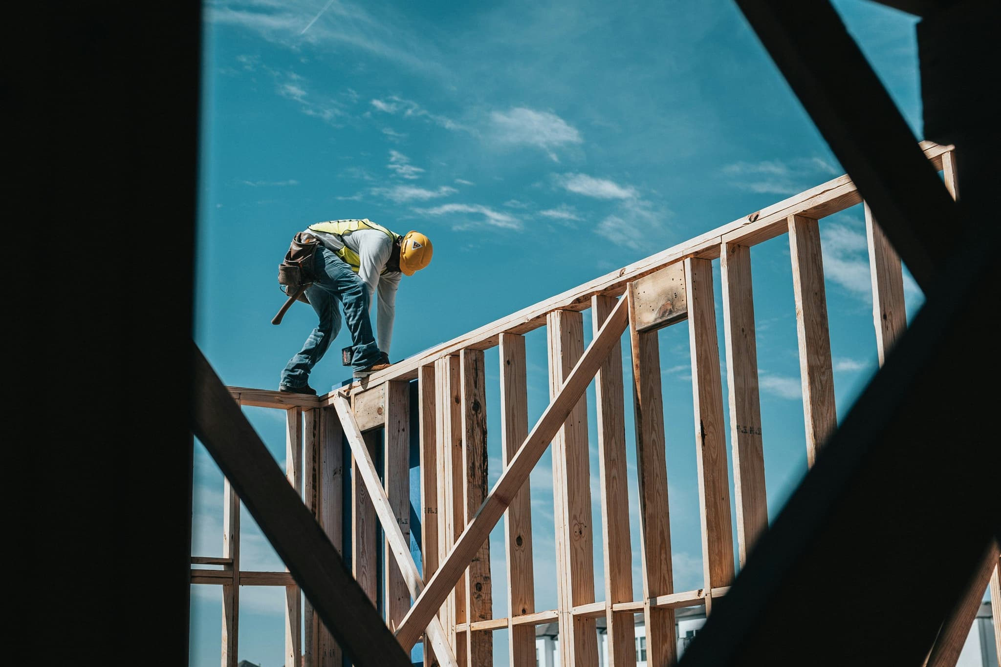 residential construction worker putting together the walls of a new build house