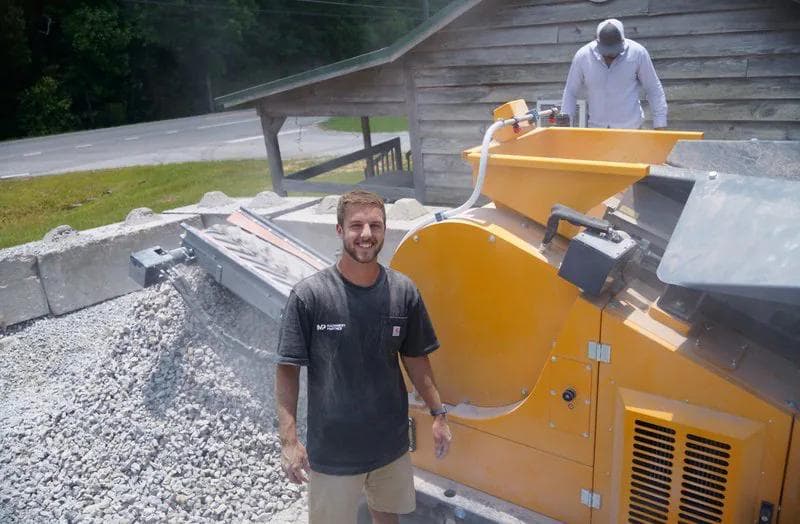chandler from machinery partner in a black t shirt crushing concrete on site with a yellow ark 503 jaw crusher
