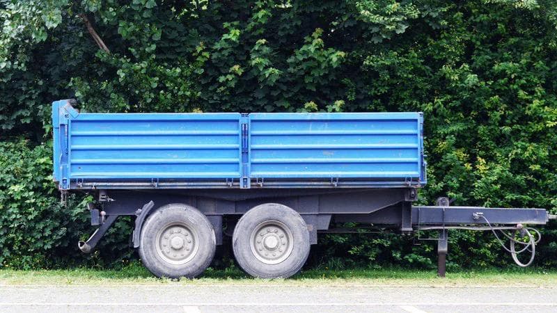 blue flat bed trailer with 4 wheels and a tow pole