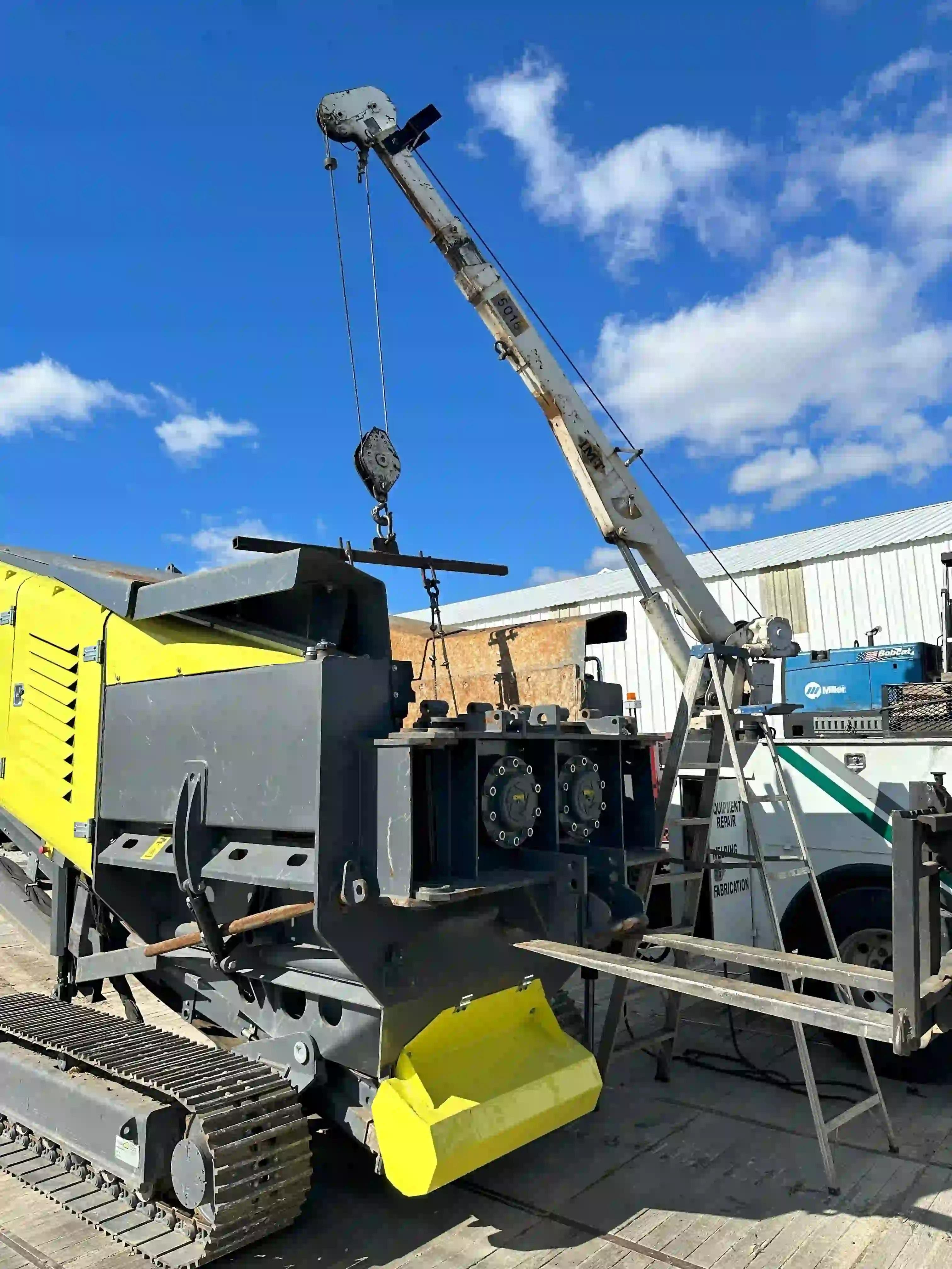 shafts being lifted into the ARK SH60 Shredder using a crane lift truck