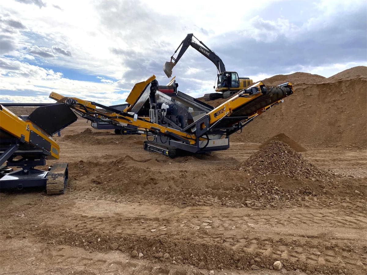barford sr124 screening 3 different sized piles of rock and feeding a barford radial conveyor