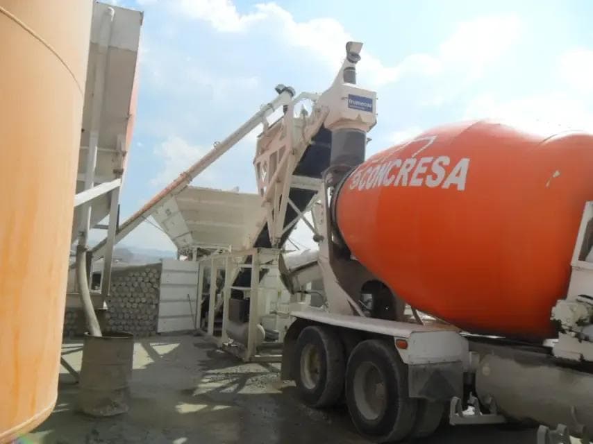 Frumecar EBA 1000 Dry Concrete plant filling up a ready mix truck with dry mix concrete