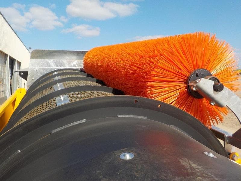 orange trommel brush cleaning a mesh screen